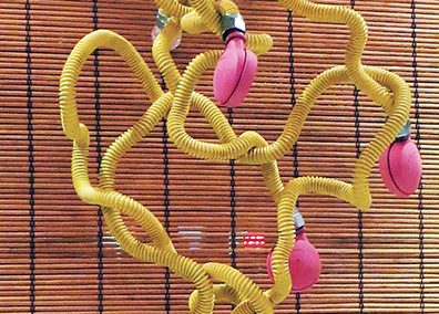 Fred Cole  – “Eight Yellow Appendages” recycled gas line, castors, plastic tips
