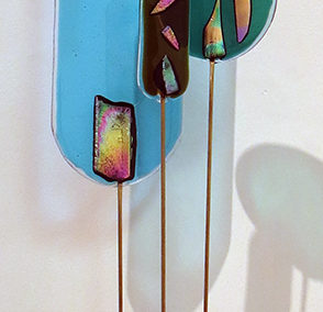“Three for One”   fused glass, brass rods and wood, by Ellen Rebarber