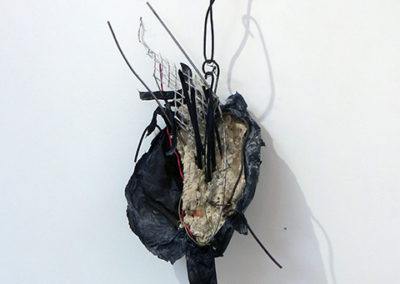 “In Time” mortar, wire, paper and found objects, by Eric Beckerich