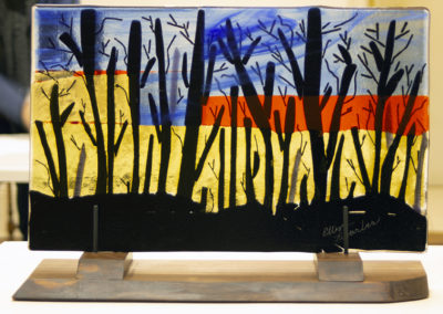 Ellen Rebarber “Waiting for the Bulldozer” fused glass on Rosewood base,11”H x 18 1/2”W, 2020