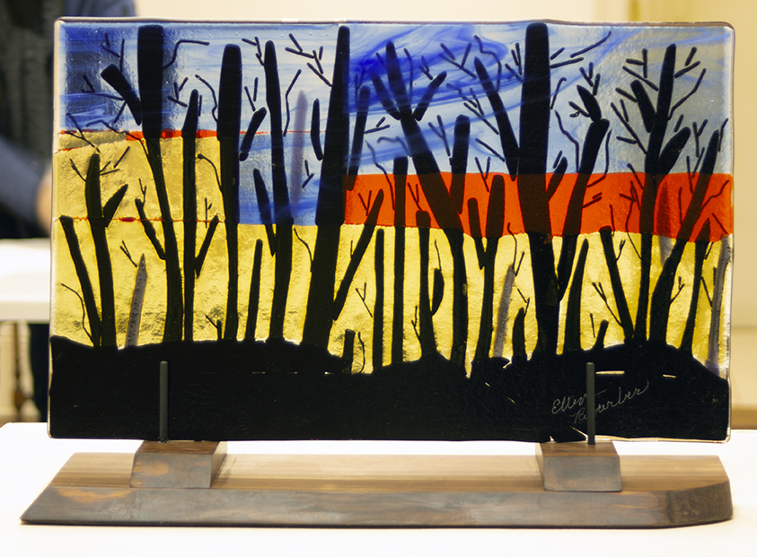 Ellen Rebarber “Waiting for the Bulldozer” fused glass on Rosewood base,11”H x 18 1/2”W, 2020