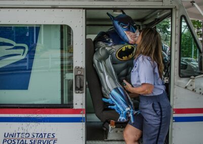 Christine Anderson “Postal worker kissing an inflatable Batman”, photograph, $300.00