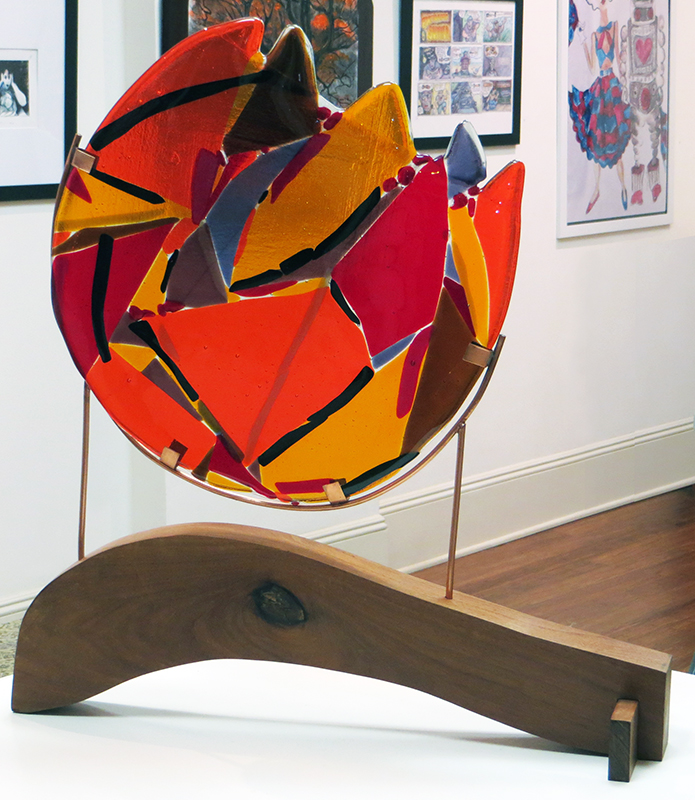 Ellen Rebarber  – “Ball of Fire” fused  glass with dichroic glass, 22”W x 21H” x 6”D, 2022, $1,200.00