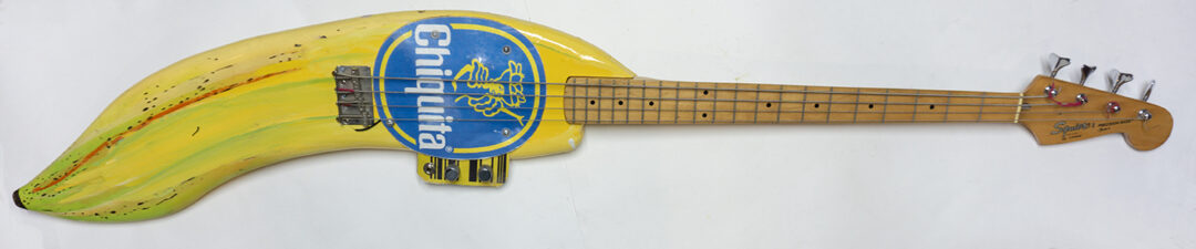 Banana Bass – cut and shaped wood, electric bass guitar parts, plexiglass, paint – $800.00