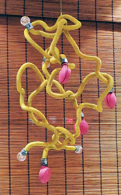 Fred Cole  – “Eight Yellow Appendages” recycled gas line, castors, plastic tips