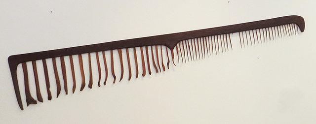 E. Carol O’Neill –  “Men’s Fine Toothed Comb in Red Cedar and Redwood” carved wooden sculpture