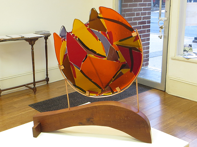“Fireball”   fused glass, copper and wood by Ellen Rebarber