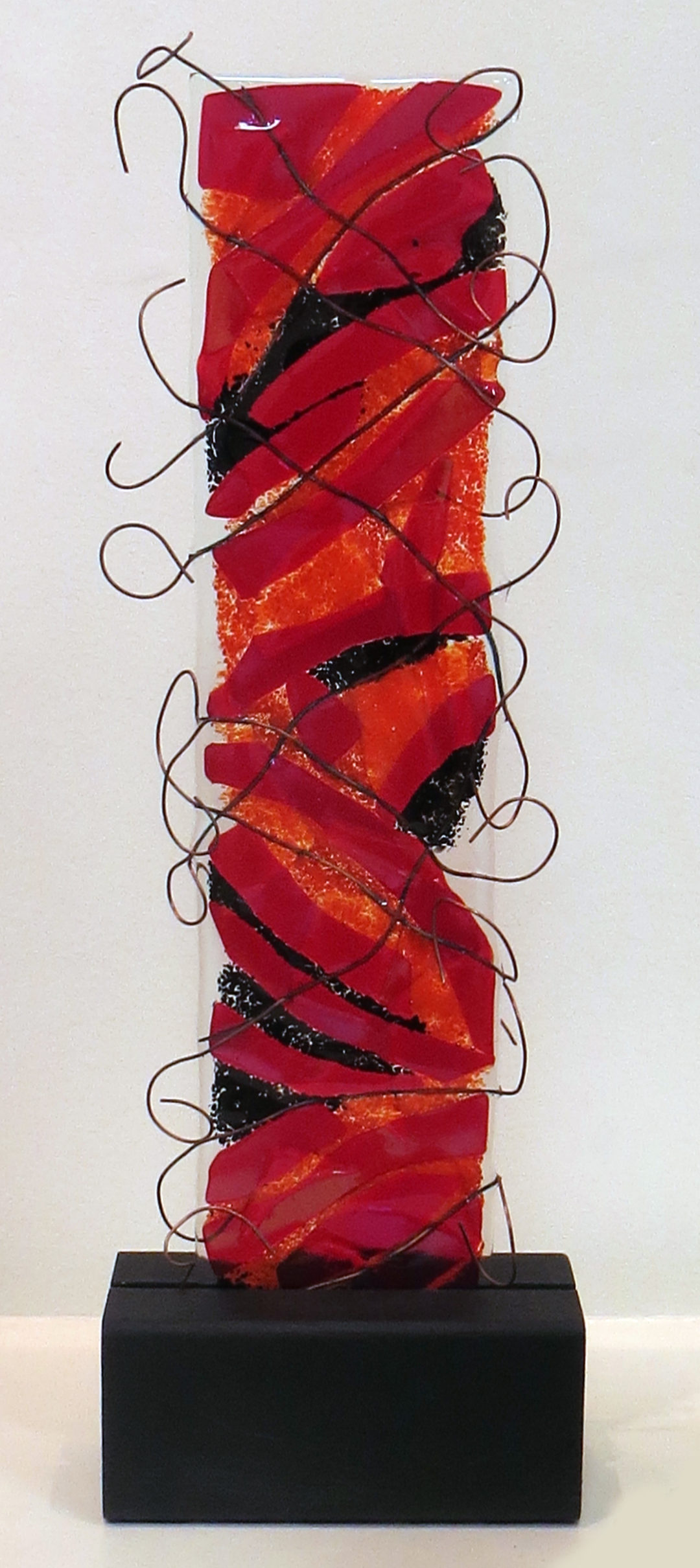 “Don’t fence me in”   fused glass and copper wire and wood,  by Ellen Rebarber