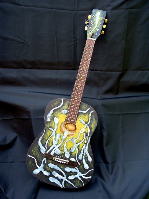 The Birth of Folk – found guitar, hot glue, wooden egg, reflective vinyl, paint