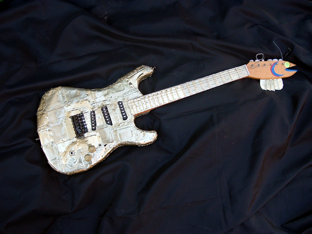 Smell-A-Caster – found electric guitar body, electric guitar parts, handmade neck and body plated with sardine cans, reflective vinyl fish scales
