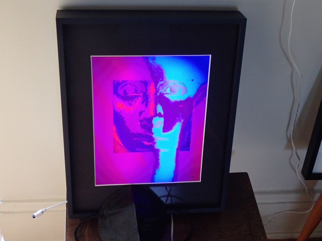 Larry McCandlish “Unmasked II (with mask)” digital image print, ink dye on luster paper w/dynamic back illumination 11.5”W x 14.5”H x 2.25” D, 2023, $600.00