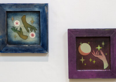 Erin  Kuhn  “Light The Way,” mixed media diptych: wood, paint, hand cut paper and vinyl, resin, mirrors, 8″ x 8″ each, 2021, $125.