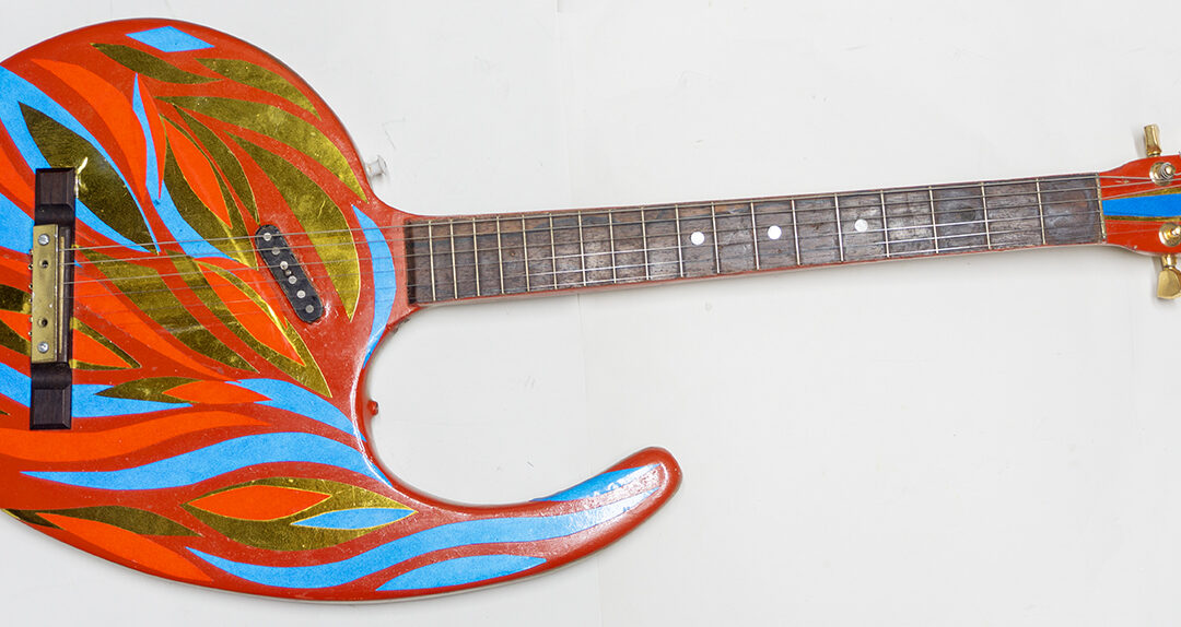 Comma Guitar – carved oak panel, electric guitar parts, paint, reflective vinyl – $300.00