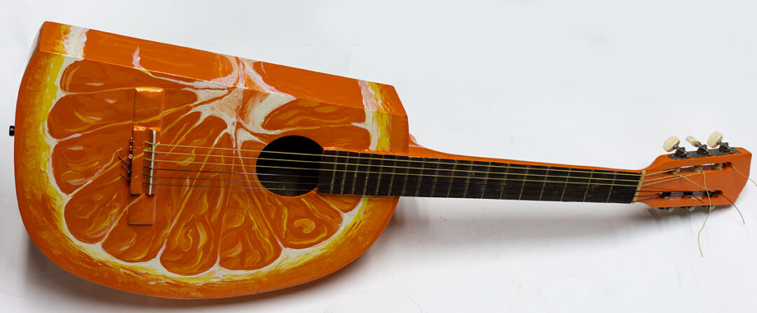 Orange Slice Guitar – found acoustic guitar with guitar parts added, paint – $300.00